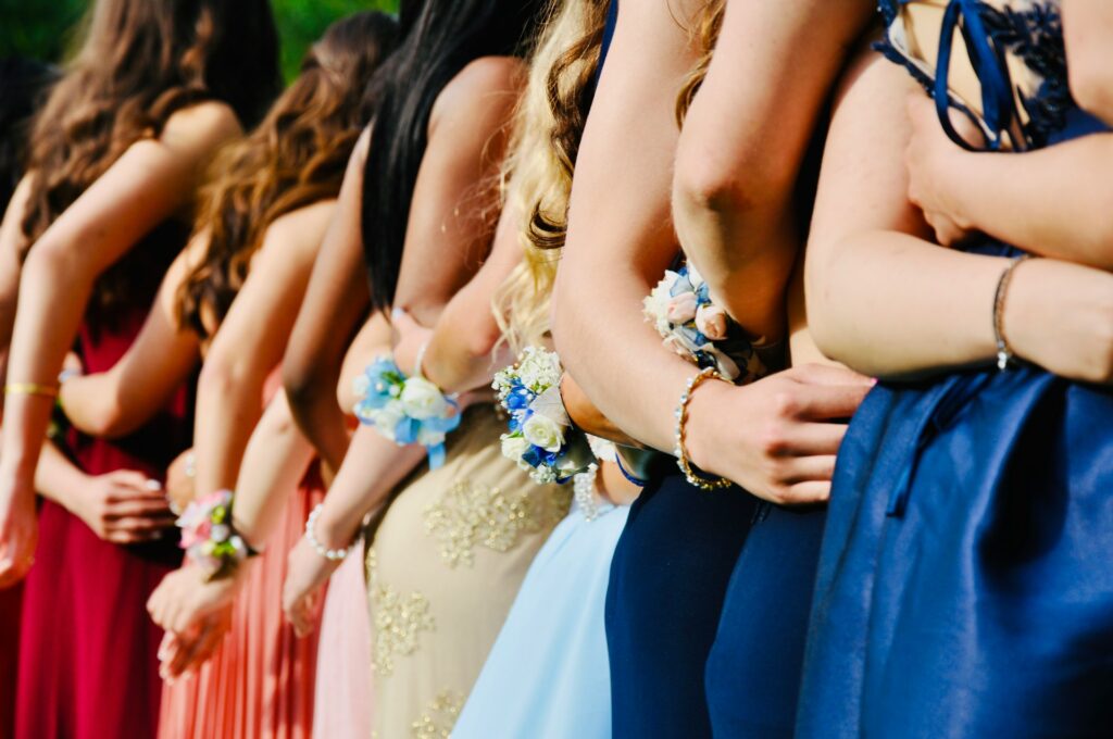 woman in blue sleeveless dress wearing blue and white floral tiara
