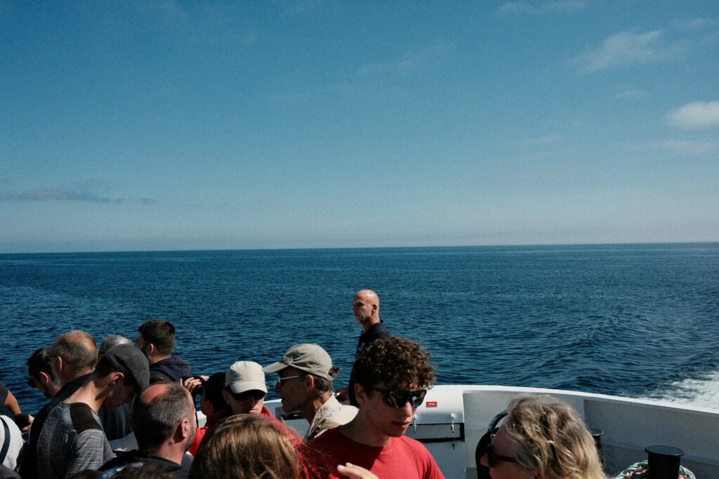 A group of people on a boat in the ocean
