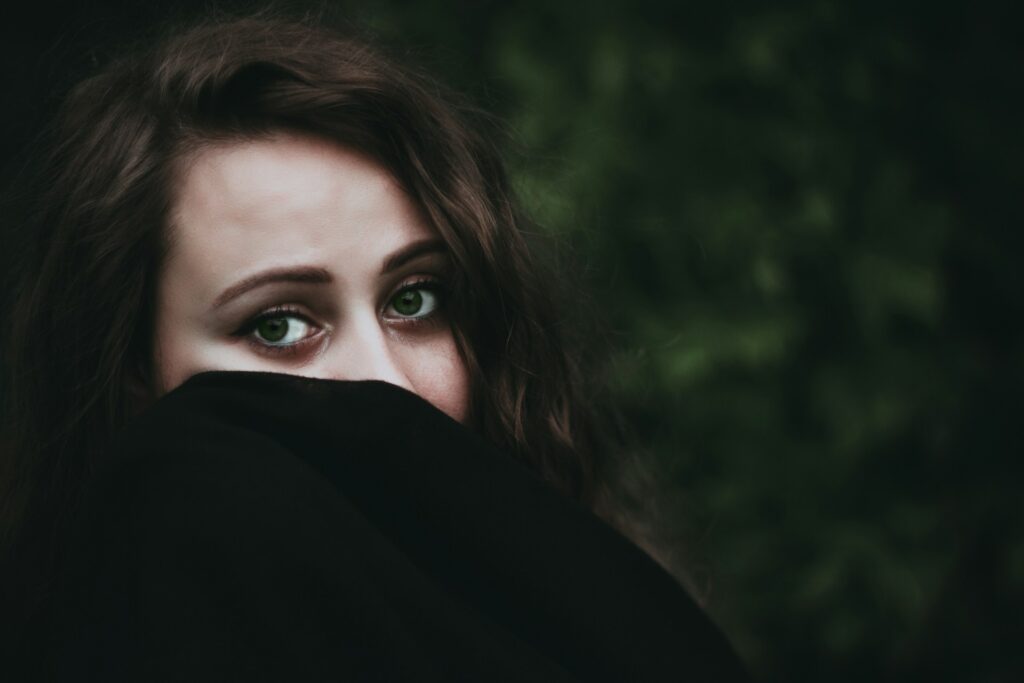 woman covering her face with black textile
