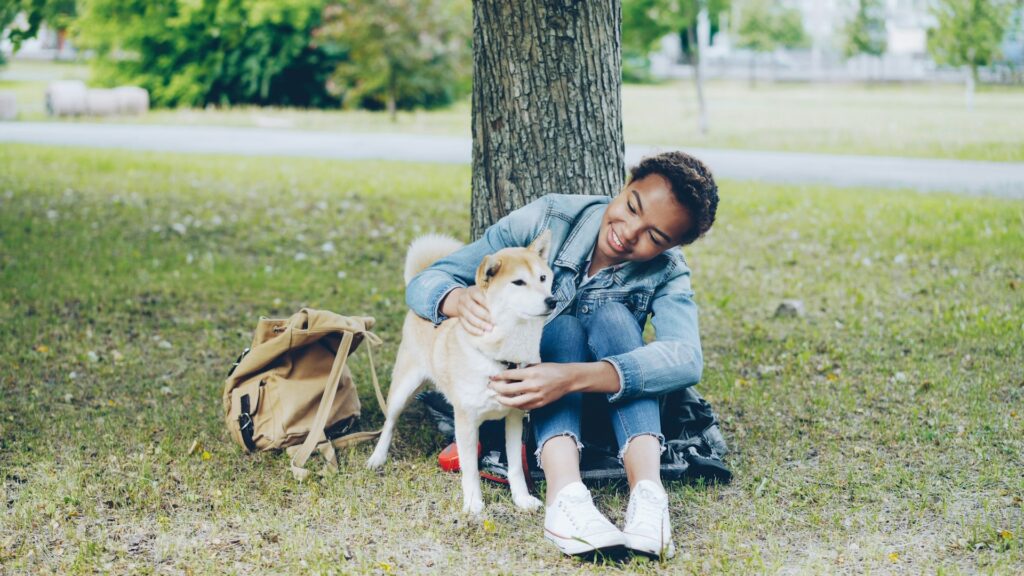 Woman and dog enjoying a relaxing time outdoors.
