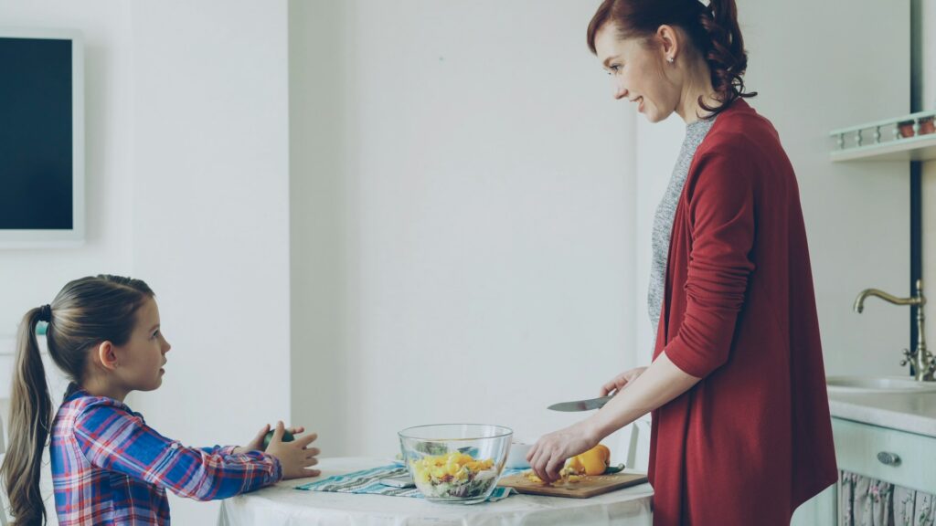 Mother and daughter cooking in the kitchen together.
