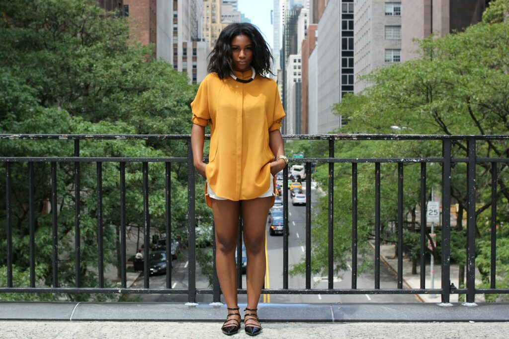 woman standing on brown bridge during daytime
