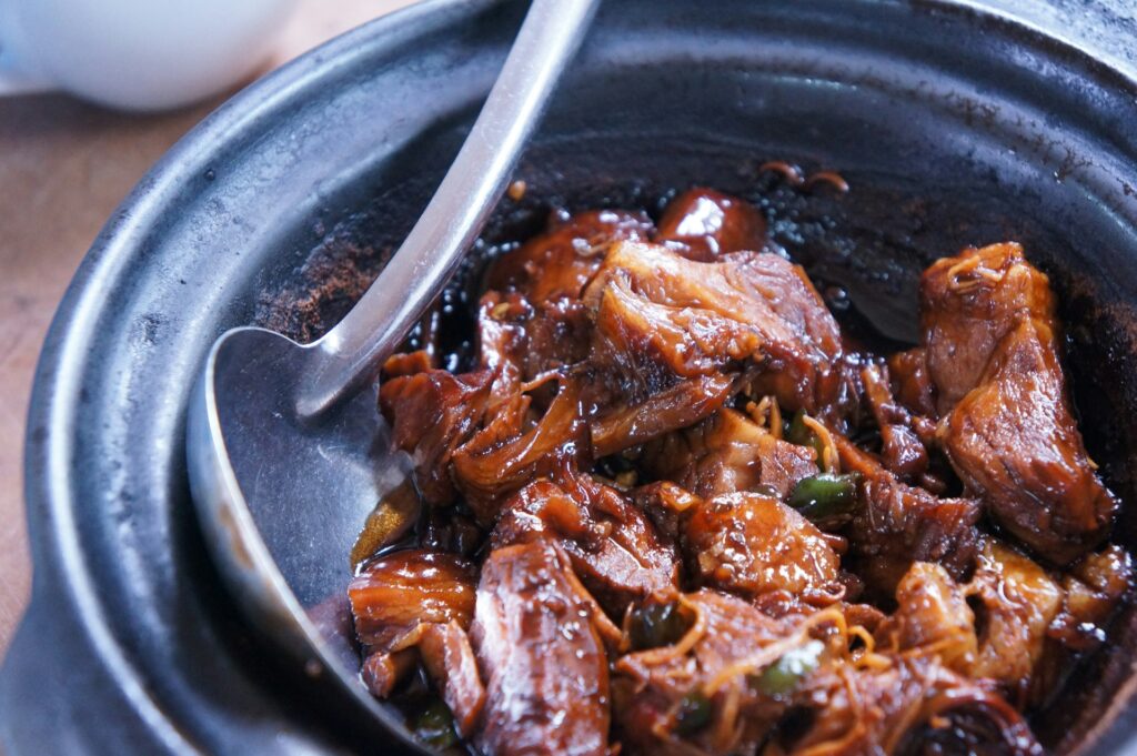 meat with sauce in black bowl

