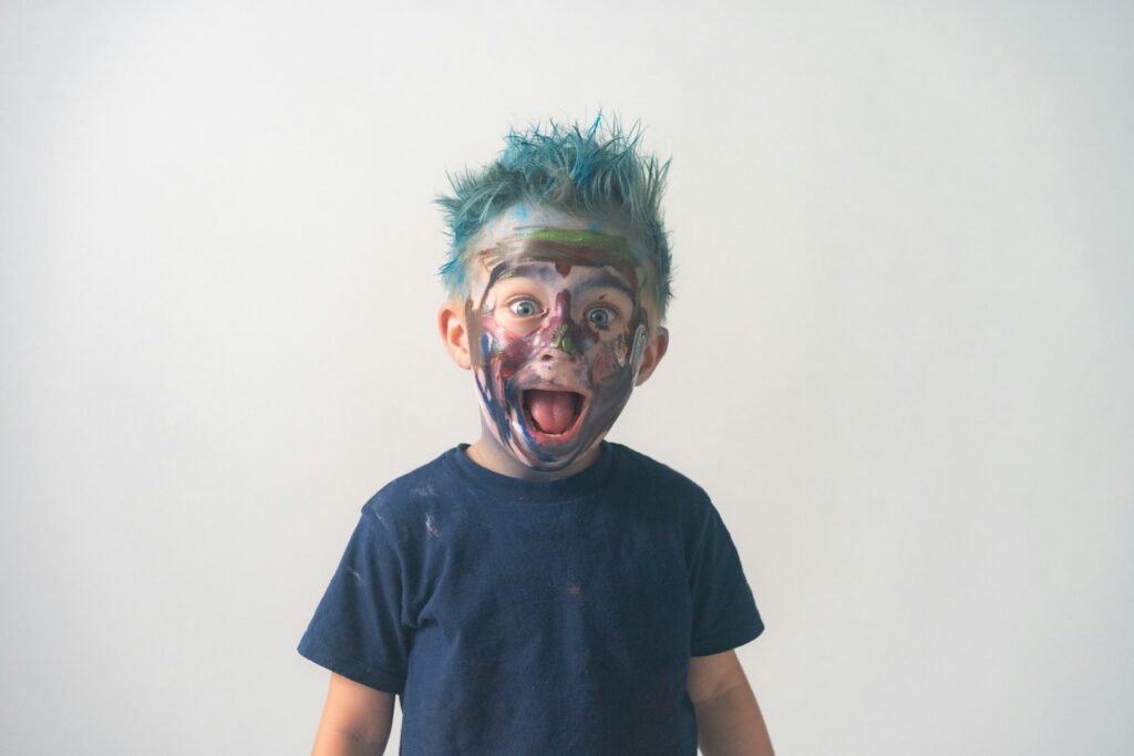 a young boy with his face painted like a zombie