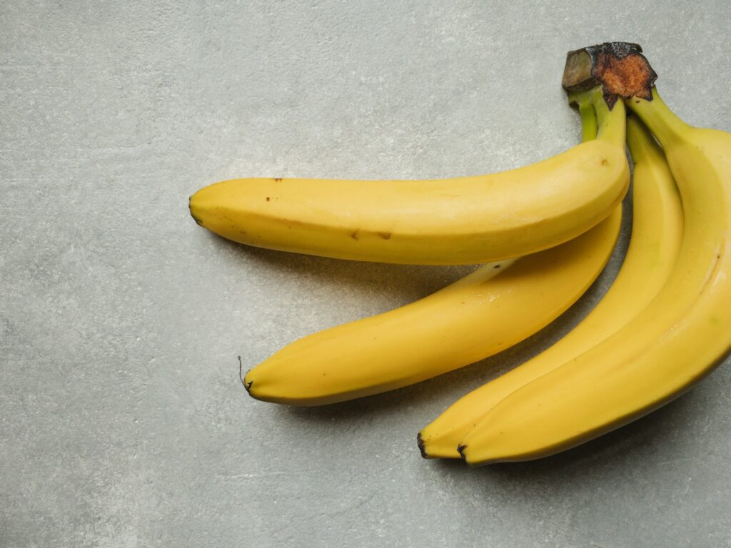 yellow banana fruit on gray table
