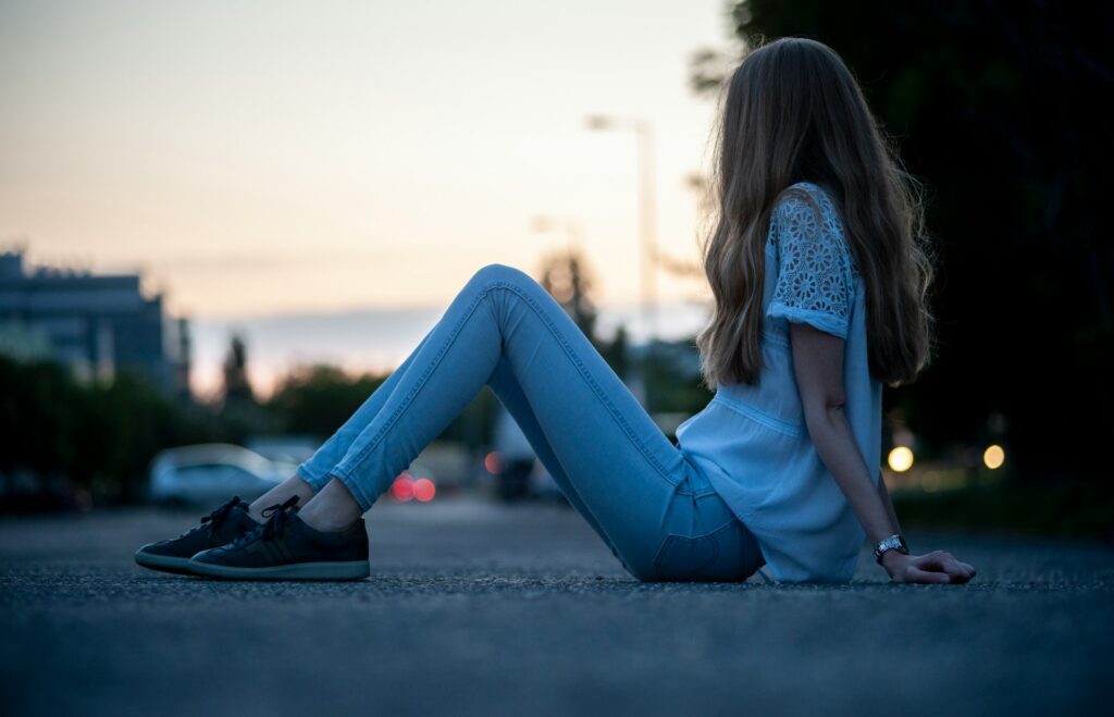 a woman sitting on the ground