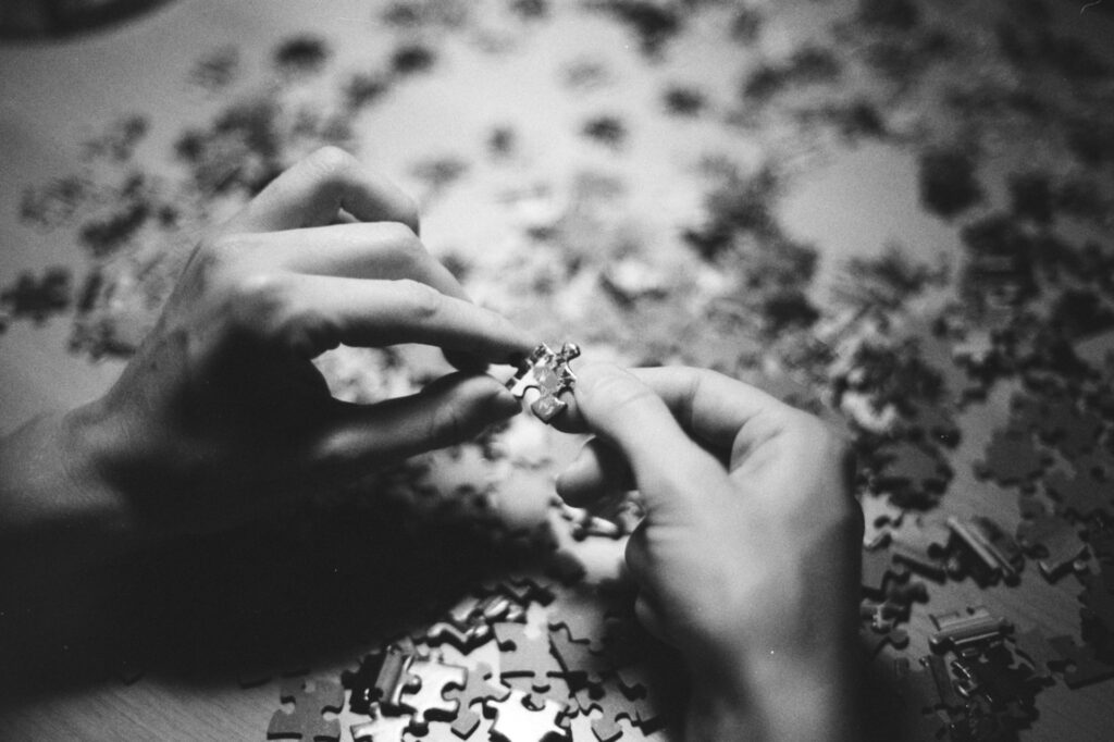 grayscale photo of person holding flower
