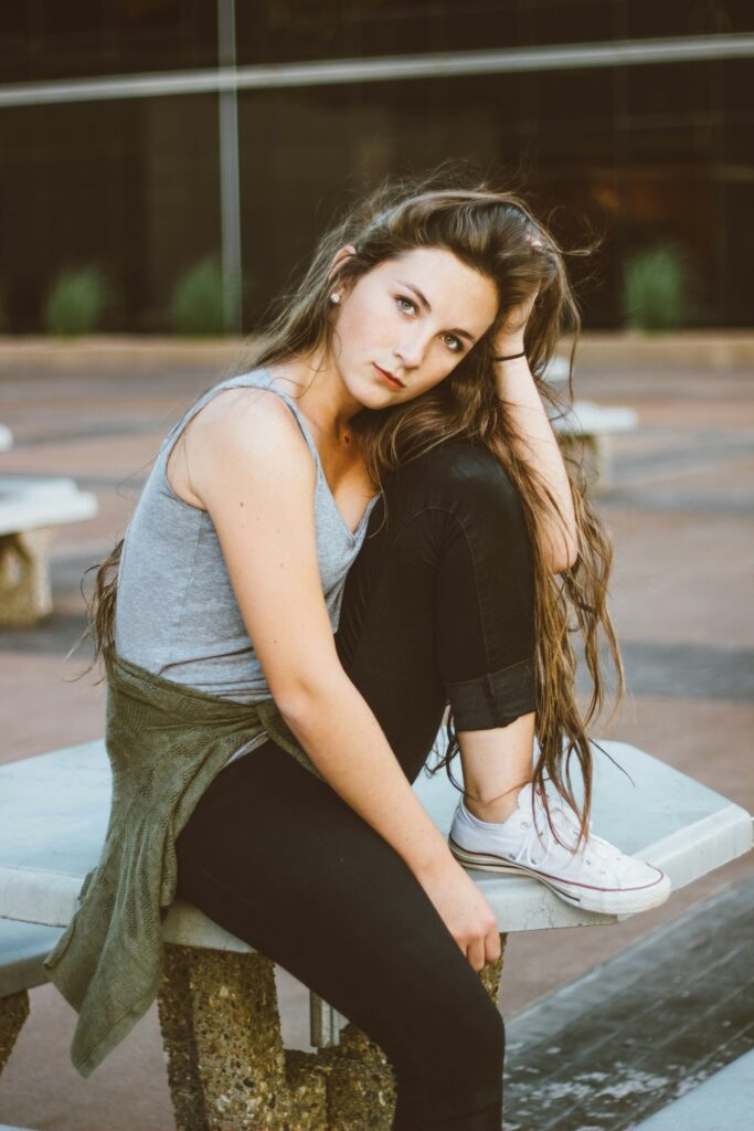 woman sitting on picnic table
