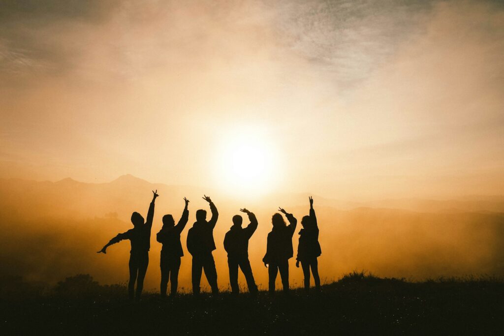 silhouette photo of six persons on top of mountain

