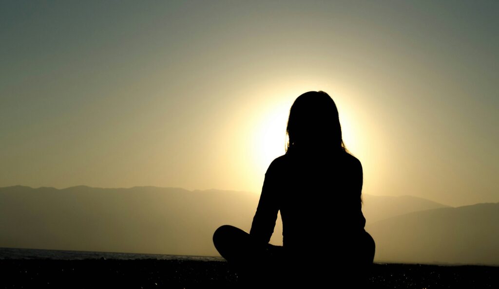 woman sitting on sand
