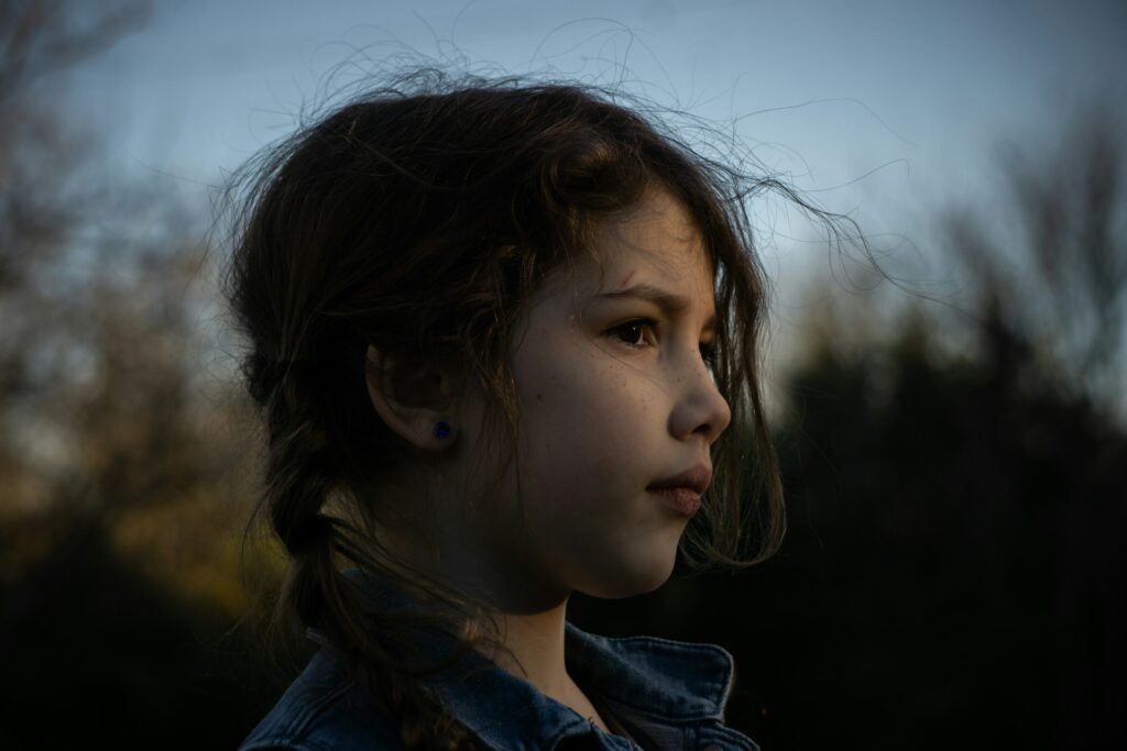 a close up of a young girl with long hair