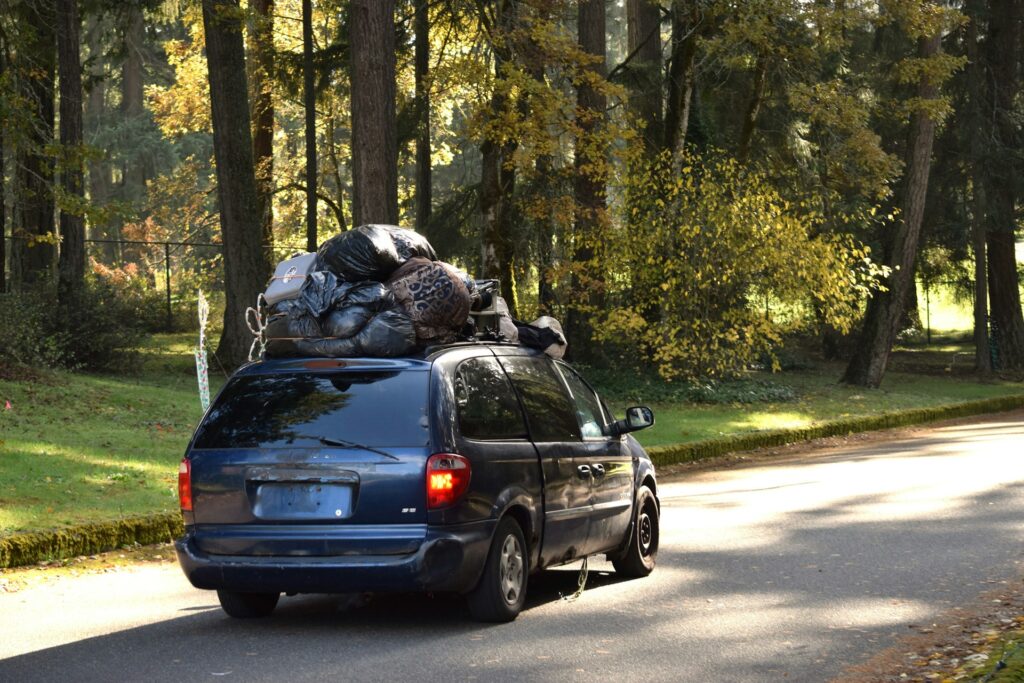 a van with a bunch of luggage on the back of it
