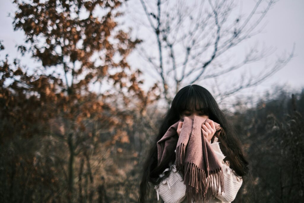 a woman with a scarf around her neck
