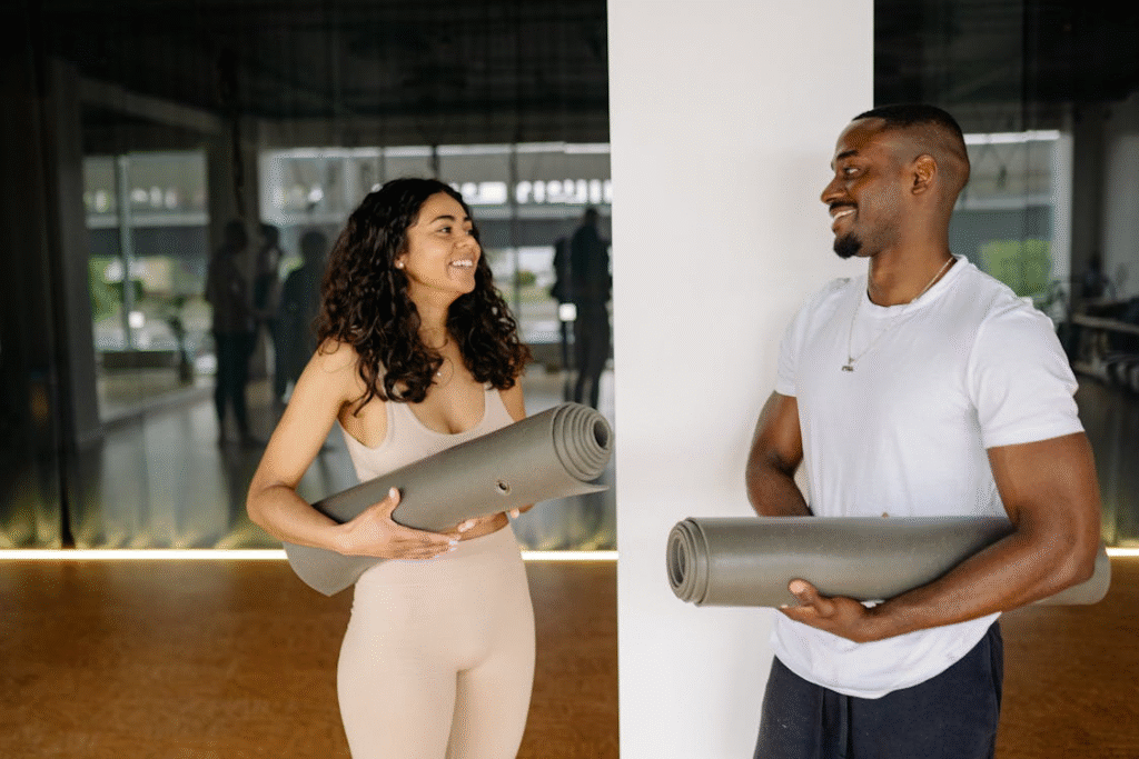 Man in White Shirt Holding Gray Yoga Mat