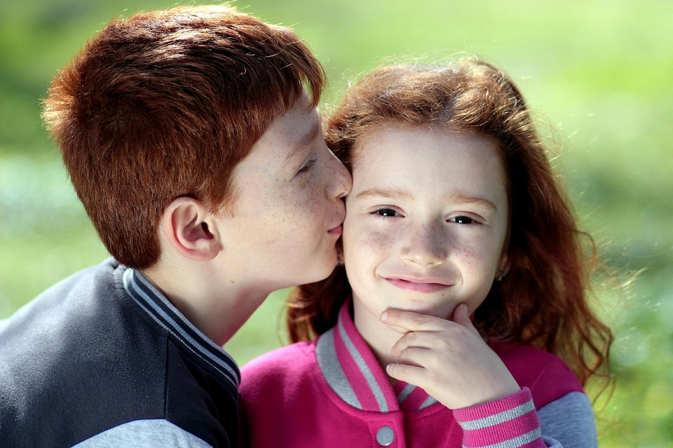 two siblings showing affection, image