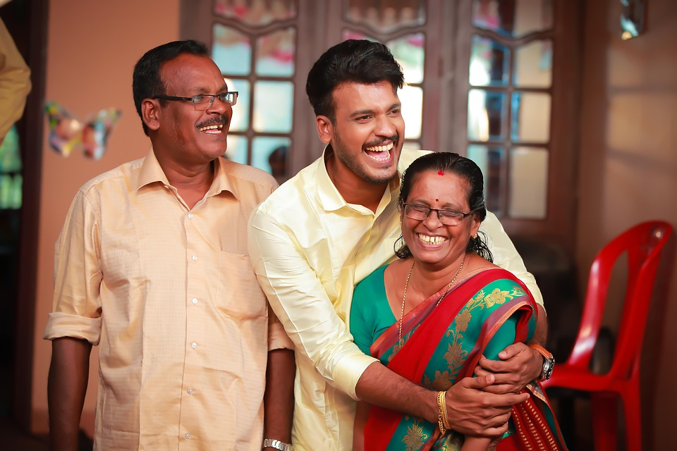 parents and adult child at a family gathering, image
