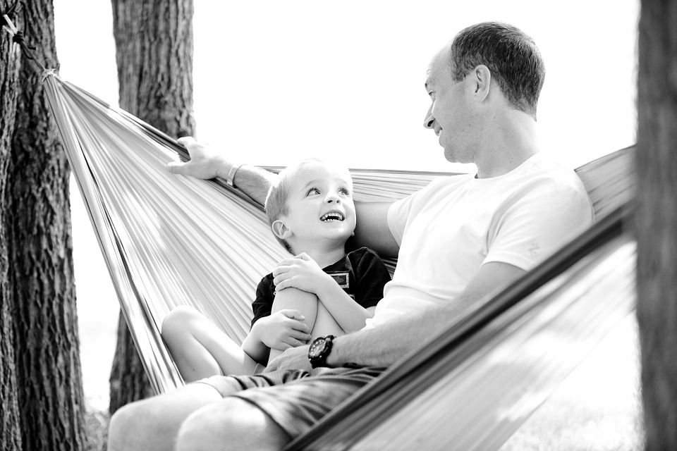 father and son in a hammock, image