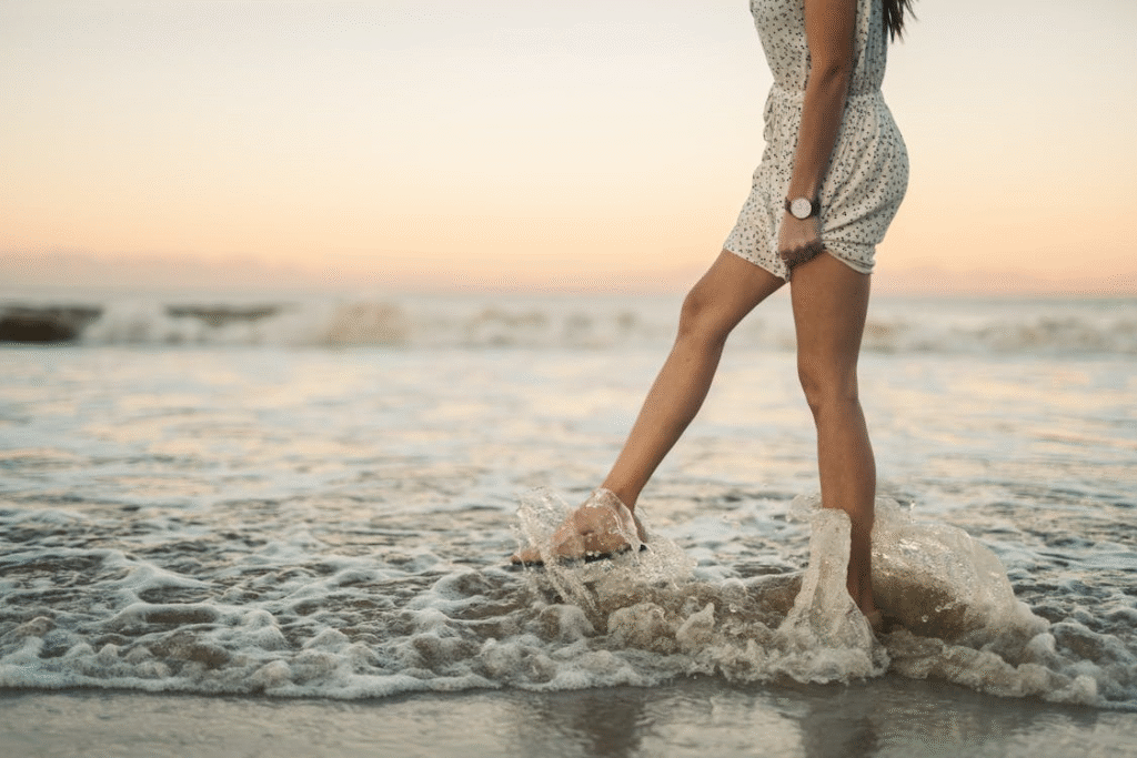 Photo of a Woman Kicking Seawater
