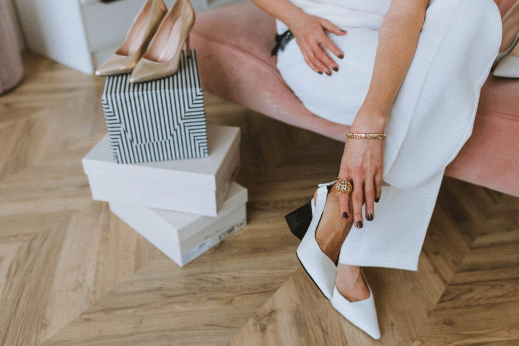 Woman in White Dress Shirt and Gold Ring Holding White Book
