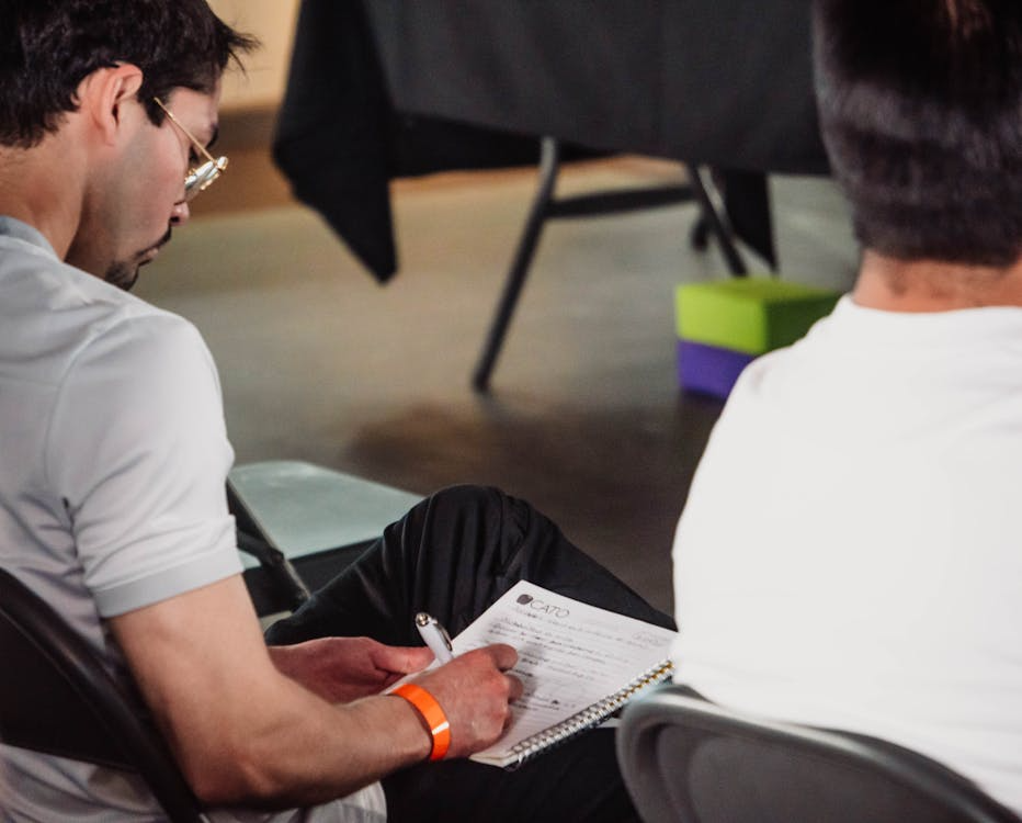 Attentive Man Taking Notes at Seminar
