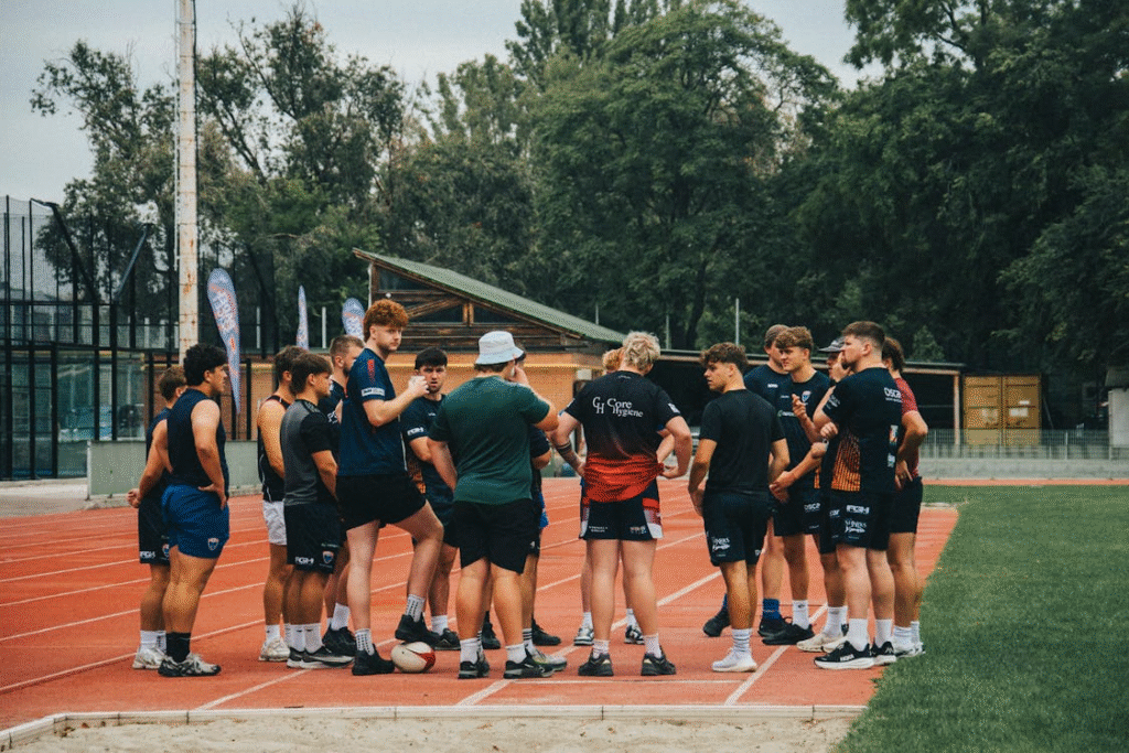 Team Huddle on Running Track Field