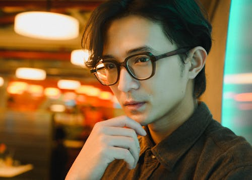 Stylish Young Man with Glasses in Modern Setting