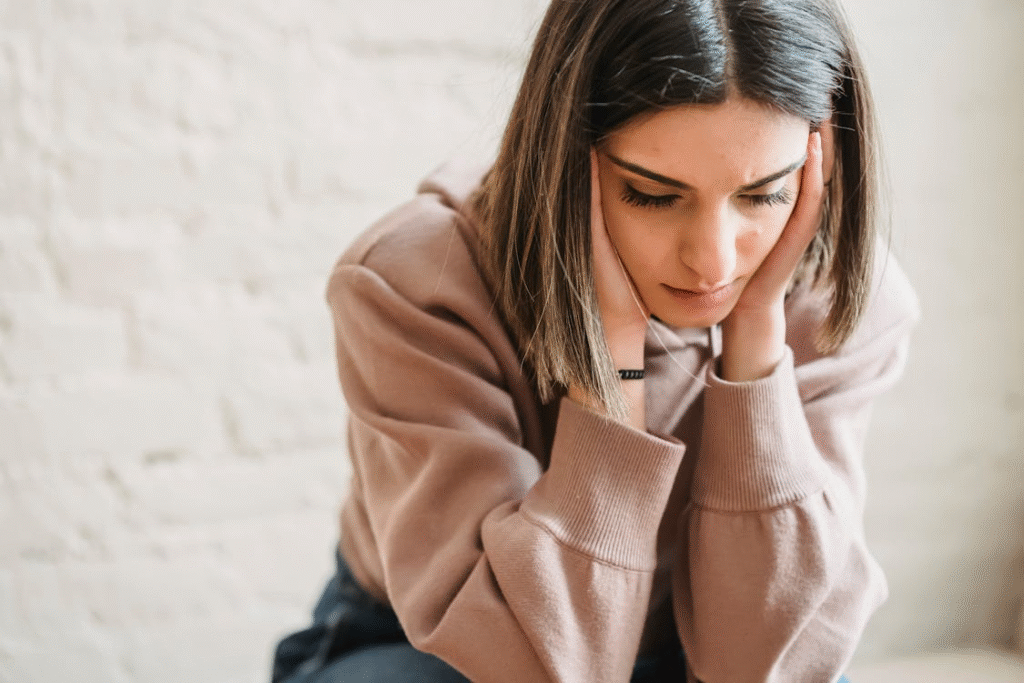 Sad woman sitting in room
