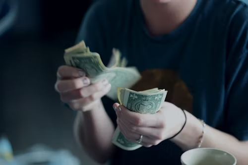 close up hands counting money.