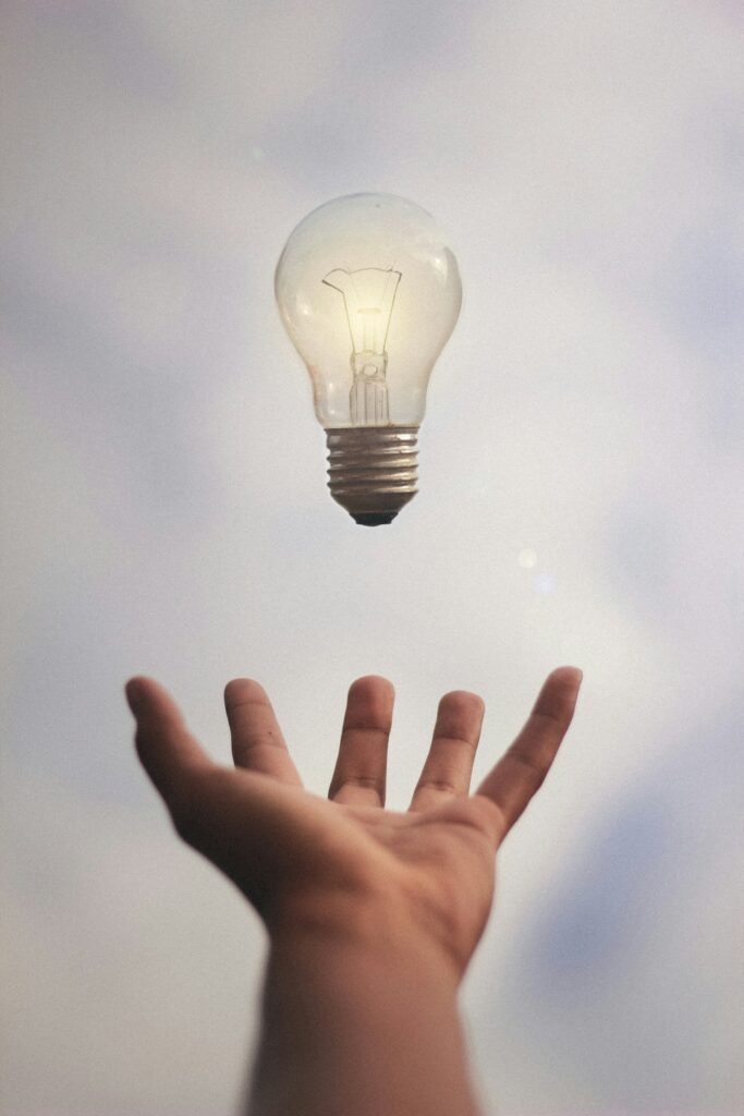 person catching light bulb
