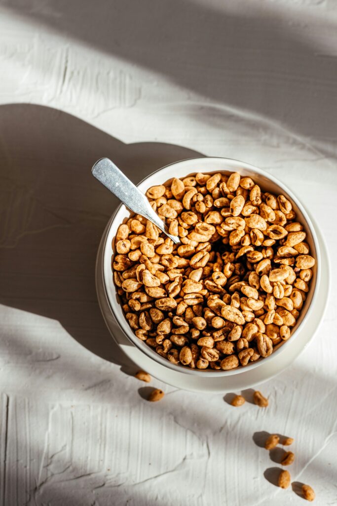 a bowl of nuts with a spoon in it
