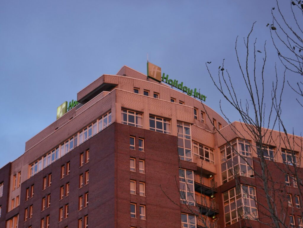 a tall building with a tree in front of it
