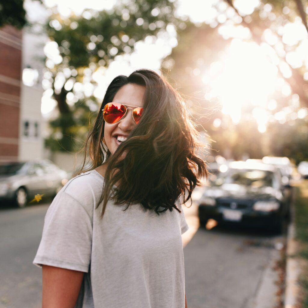 woman wearing white T-shirt smiling
