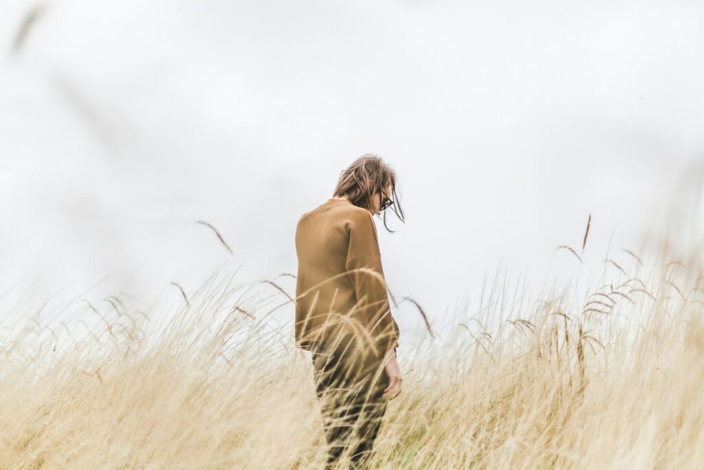 person standing in the middle of wheat field
