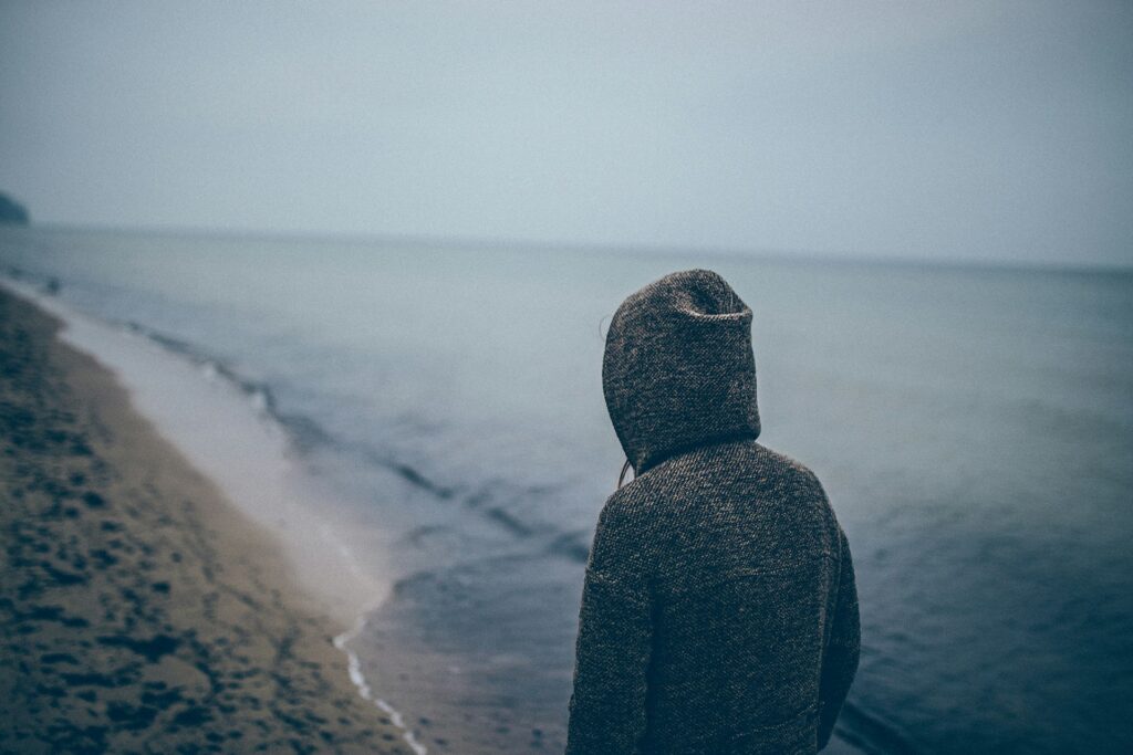 person standing beside seashore
