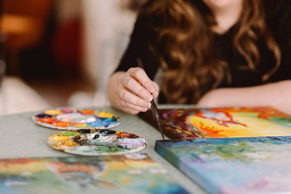 Female Artist Engaged in Vibrant Painting Session

