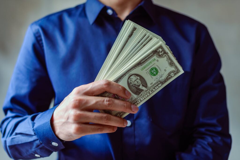 Person Holding US Dollar Bills