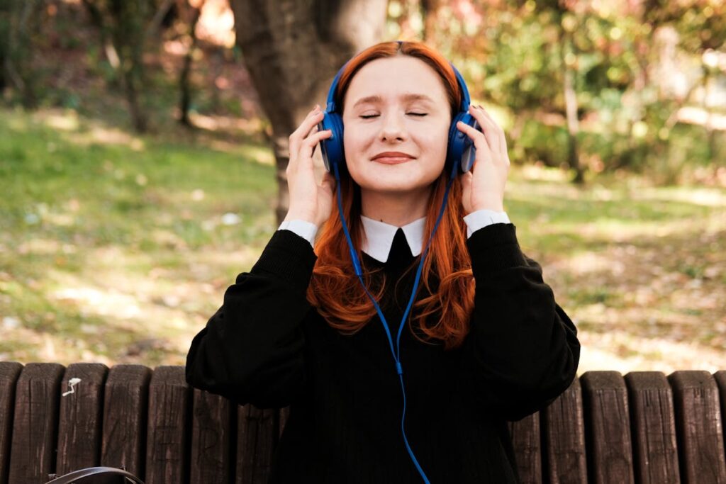 Relaxed Woman Listening to Music Outdoors
