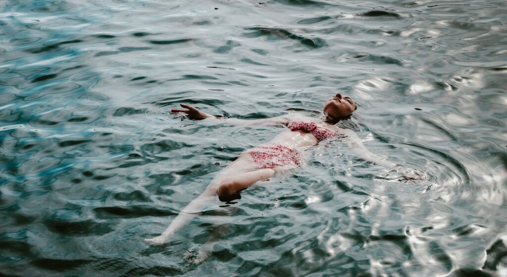 A Woman Swimming in a Lake
