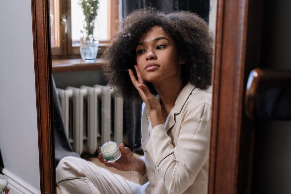 reflection of woman applying make-up