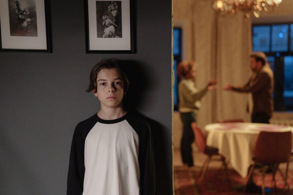 Parent arguing while boy listens afar