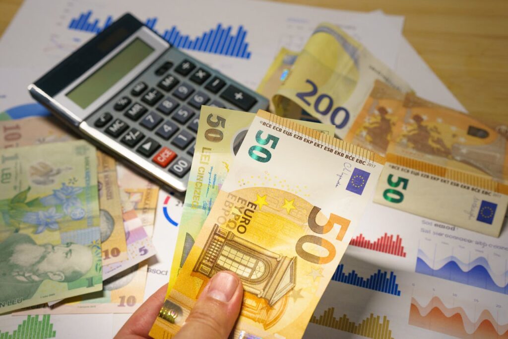 Euro and Lei Banknotes with Calculator on Desk