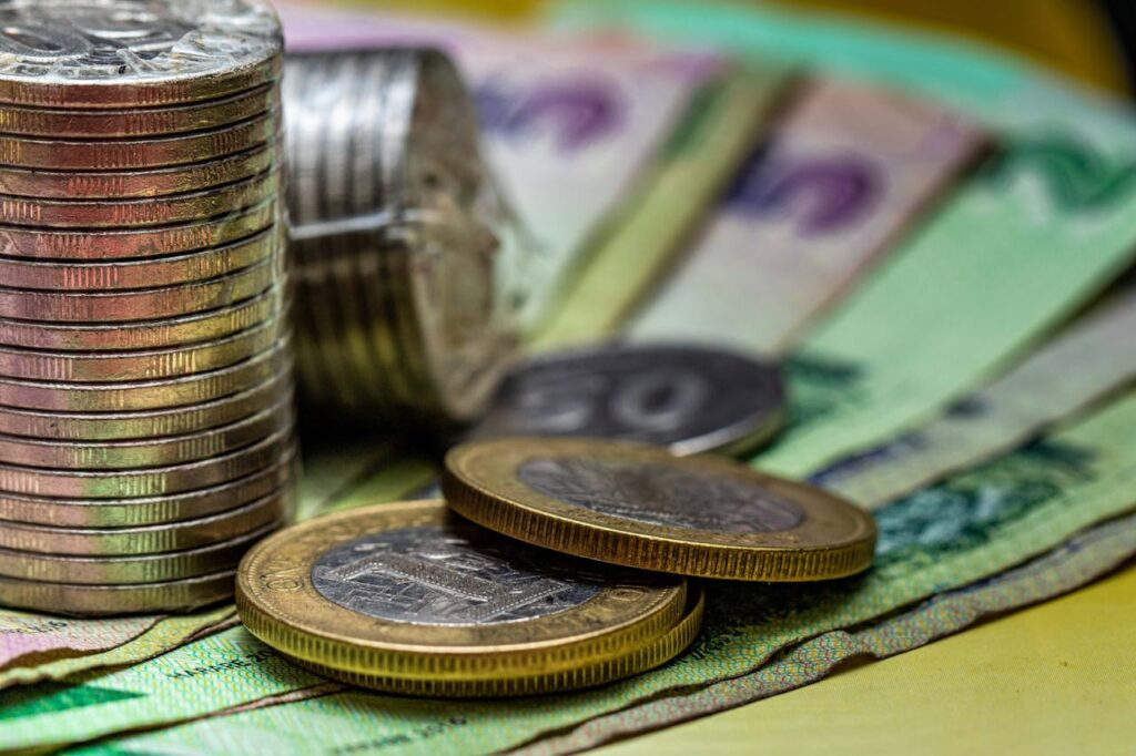 Close-Up Shot of Coins and Bills