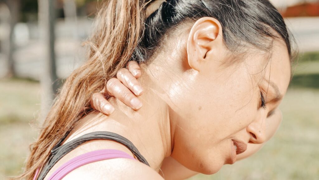 Close-Up Photo of Woman Having a Neck Pain
