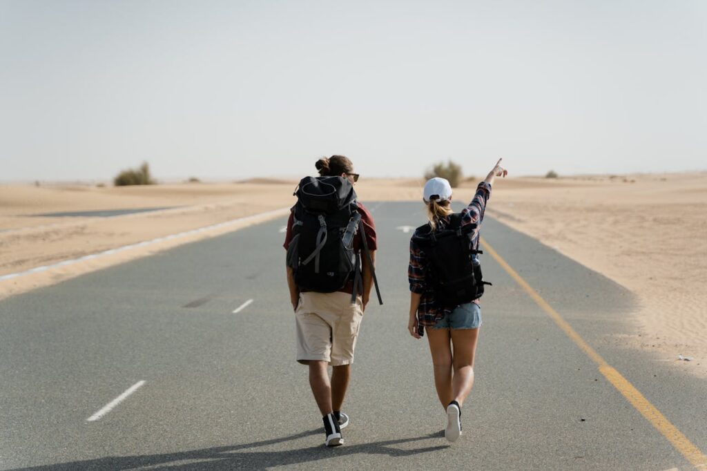 People Carrying Backpack Walking on Road
