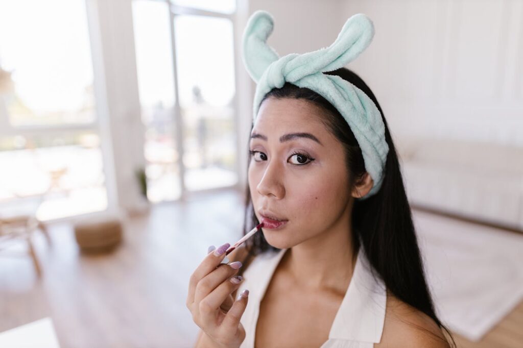 Woman Using Lipstick