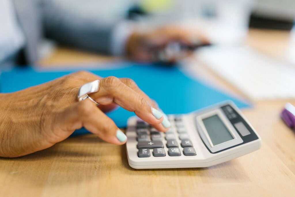 Person Holding Gray Desk Calculator