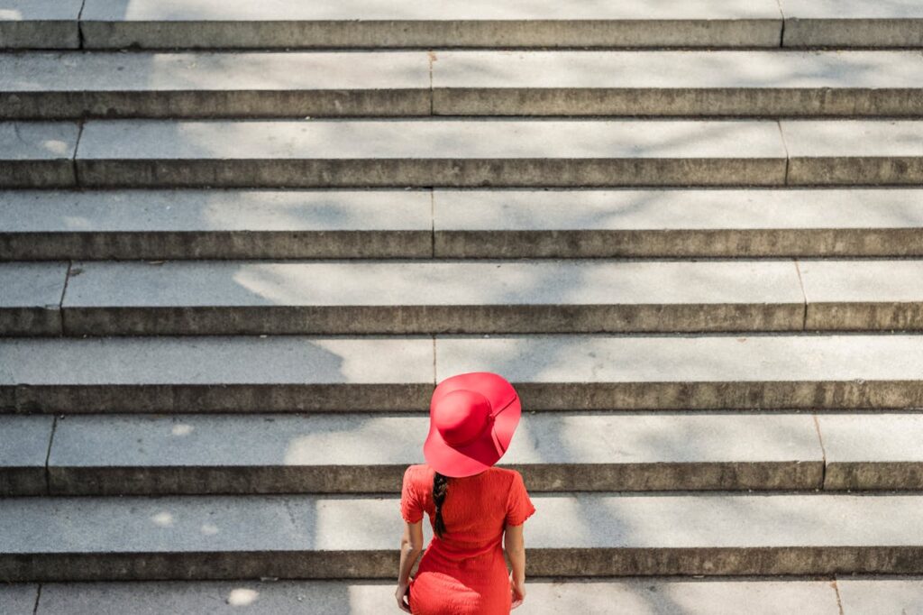 Woman in Red Dress Climbing the Stairs
