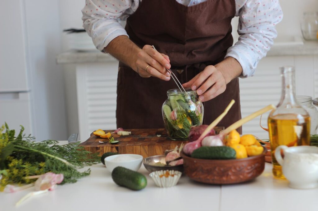 A Chef Putting Salad in a Jar
