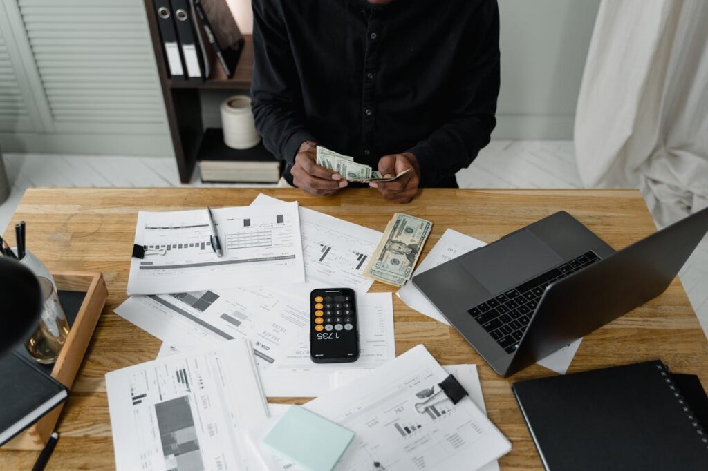 A Person Counting Dollar Bills