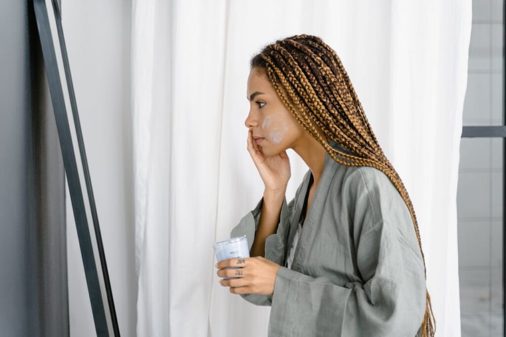 Woman applying Facial Moisturizer on her Face